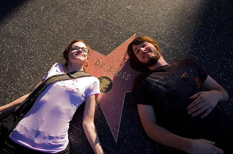 Rainy and Joe laying next to the star for Dr. Seuss on the Walk of Fame in Hollywood, California
