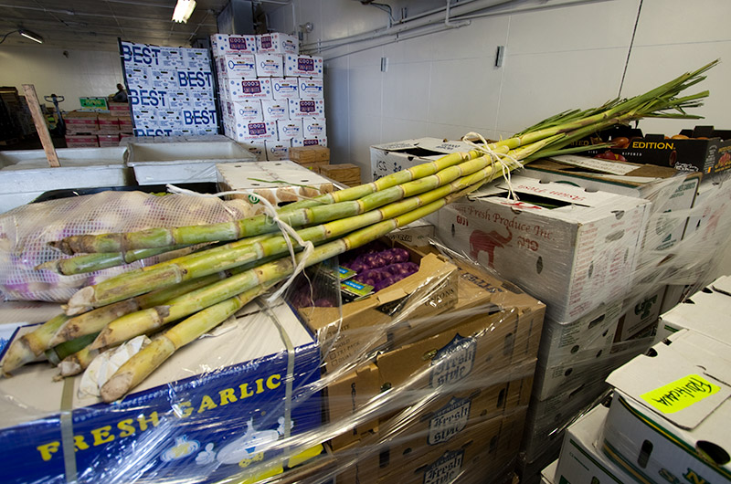 Sugar cane and various vegetables packed and ready for shipment from Samra Produce in Los Angeles, California