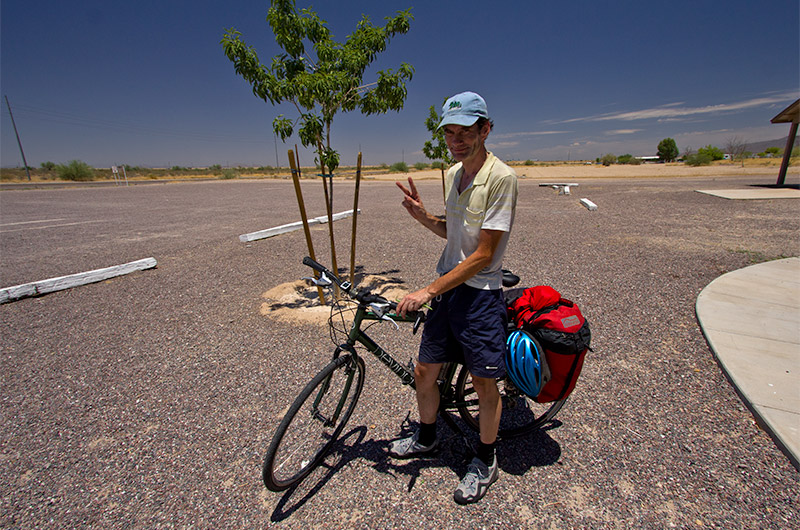 Pascal from Montreal, Canada riding his bike across America takes rest off the I-10 in Arizona where it was already over 100 degrees before mid-day
