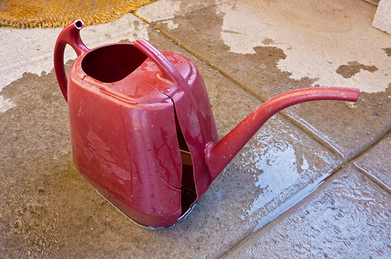 Trusty red watering can broke its handle, fell to the ground and exploded