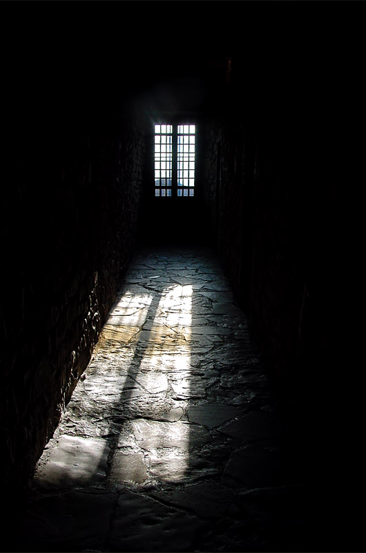 Looking into a darkened cell at Fort Niagara in New York