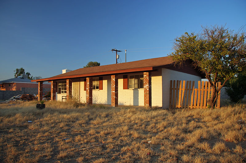 An abandonded house sits in Phoenix being vandalized as it sits empty