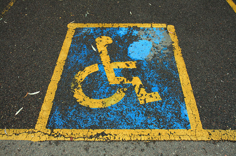 Handicapped parking marker painted on asphalt