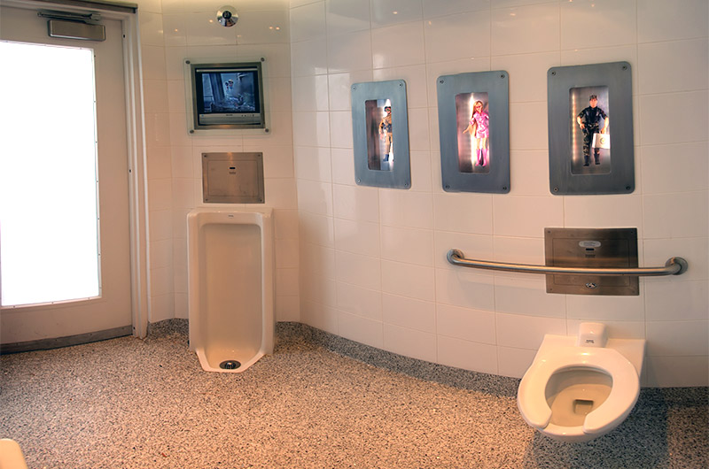 The bathroom with TV and toys on display at Joe's Farm Grill in Gilbert, Arizona