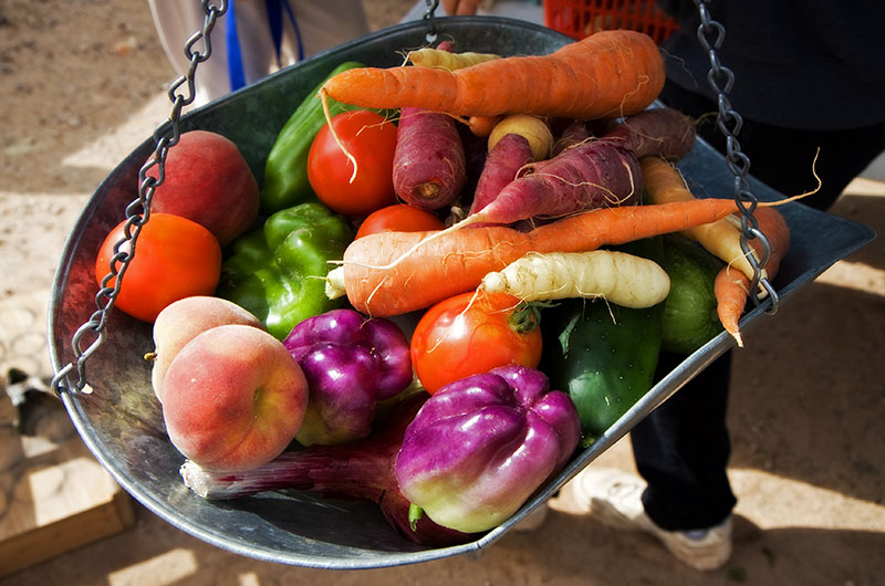 Various fruits and vegetables on the scale being weighed for sale at Tonopah Rob's Vegetable Farm in Tonopah, Arizona