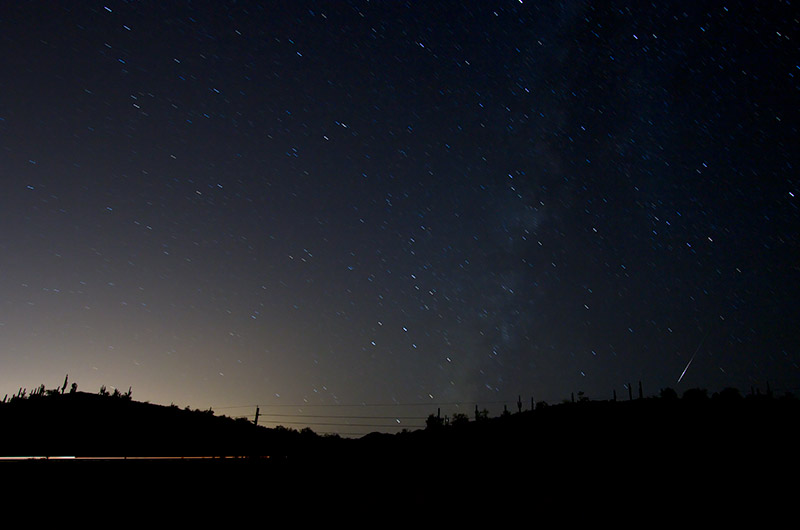 The milky way and a small streak from a meteor just over the horizon during the 2010 perseids meteor shower as seen from Lake Pleasant in Phoenix, Arizona