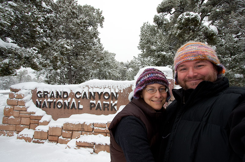 Caroline Wise and John Wise in front of the Grand Canyon National Park entry sign
