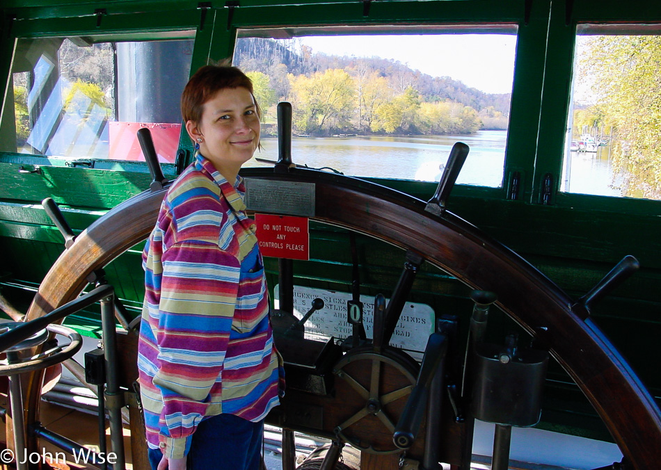 Caroline Wise in the wheelhouse of a steamboat in Marietta, Ohio