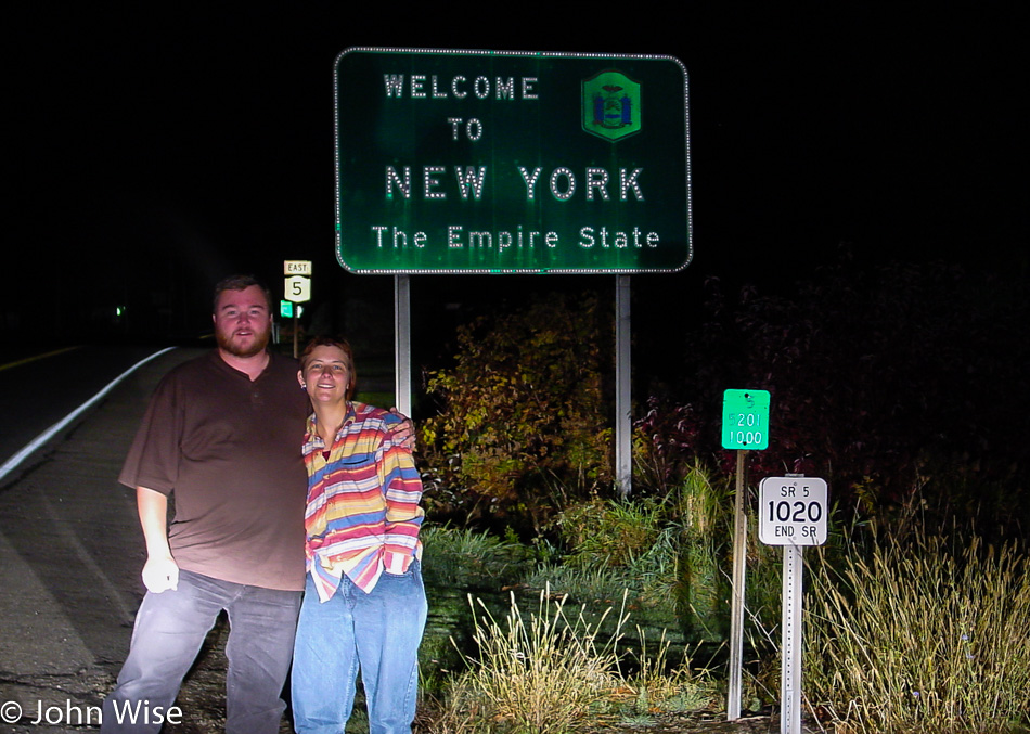 Selfie of Caroline Wise and John Wise in front of the Welcome to New York state sign