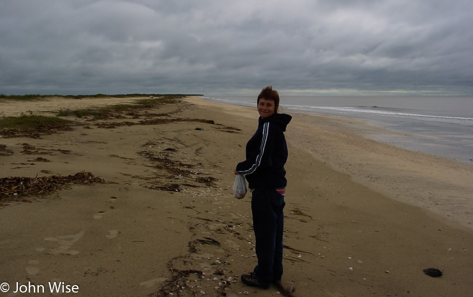 Caroline Wise with a bag of shells on the shore of the Gulf of Mexico in Louisiana