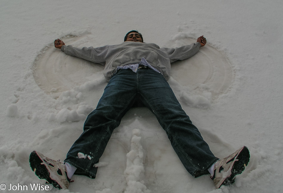 Jay Patel making a snow angel in Yellowstone National Park