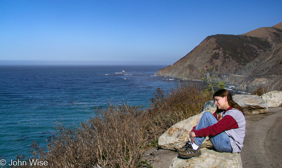 Caroline Wise sitting next to Highway 1 on the way io Big Sur, California