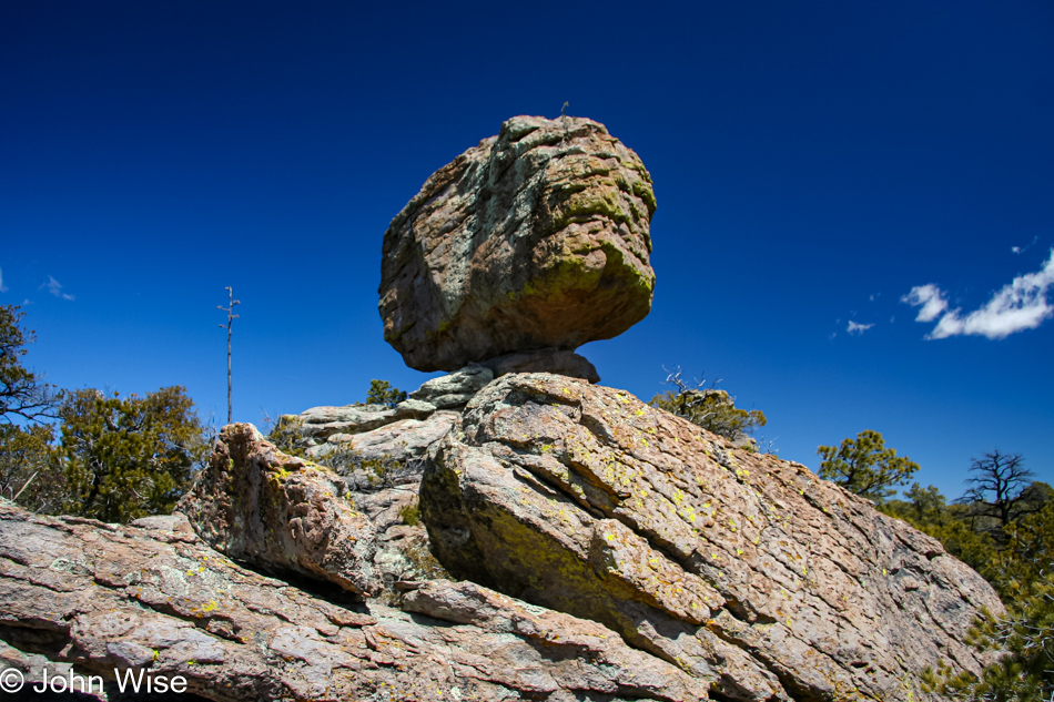 A large balanced rock perched precariously on a much smaller rock in Chiricahua National Monument, Arizona