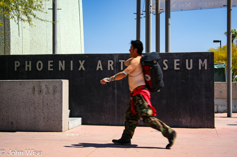 A man on the street in front of the Phoenix Art Museum in Arizona