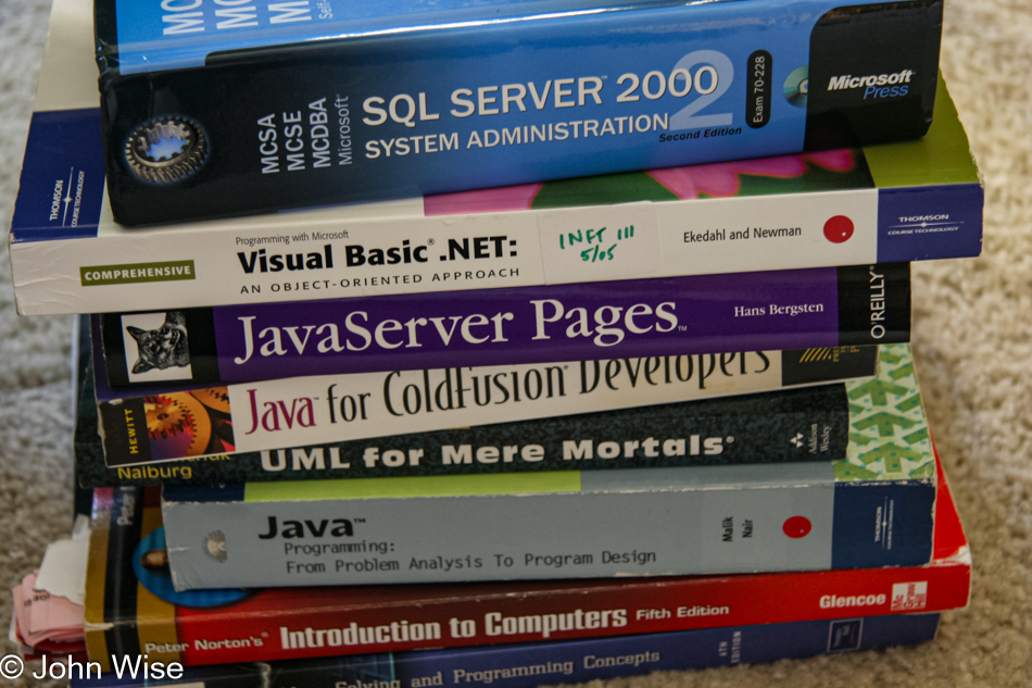 A stack of books Caroline is using as part of getting her degree and what she needs to further her programming skills