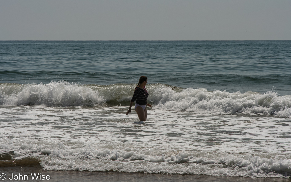 Caroline Wise in the surf near Seacliff, California