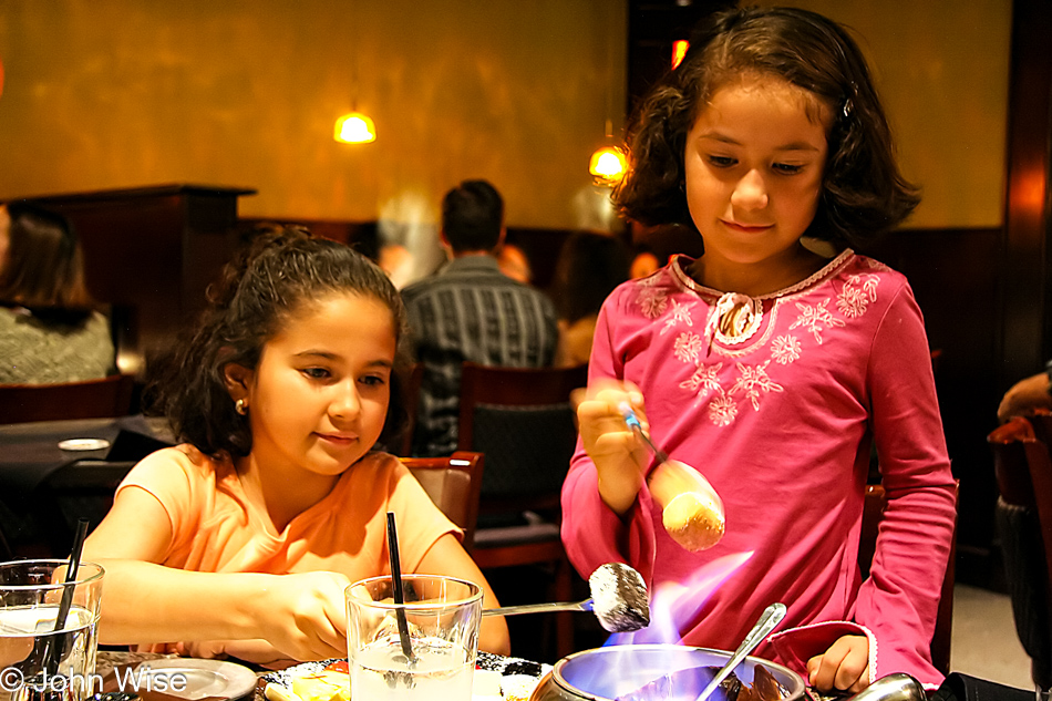 Mellisa and Sophia Silva loving the chocolate fondue at the Melting Pot in Tucson, Arizona