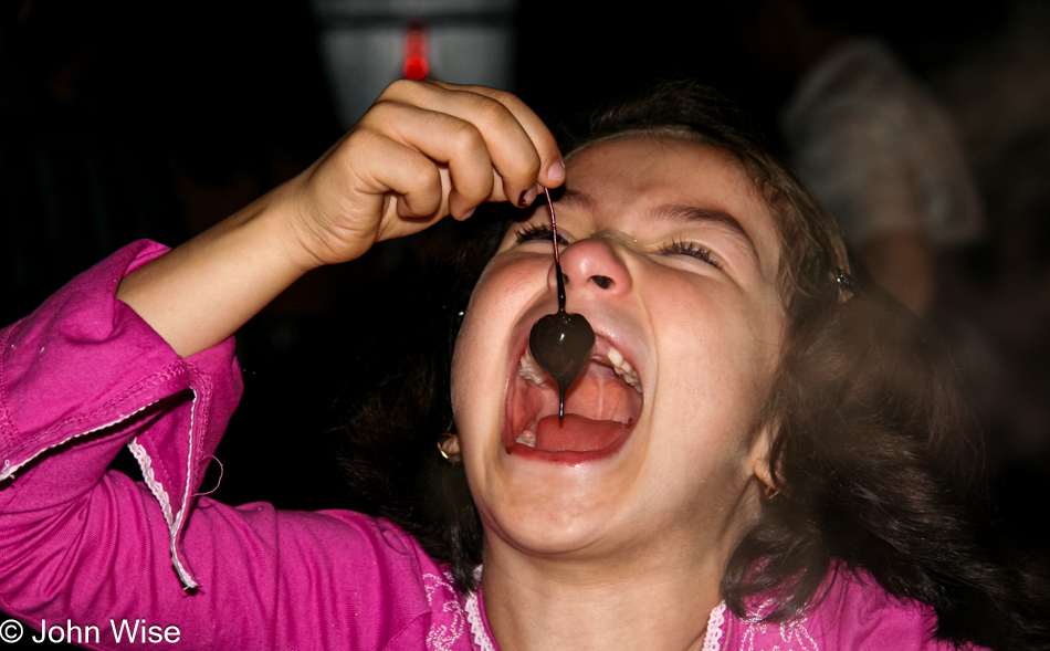 Sophia Silva enjoying a chocolate dipped cherry at The Melting Pot in Tucson, Arizona