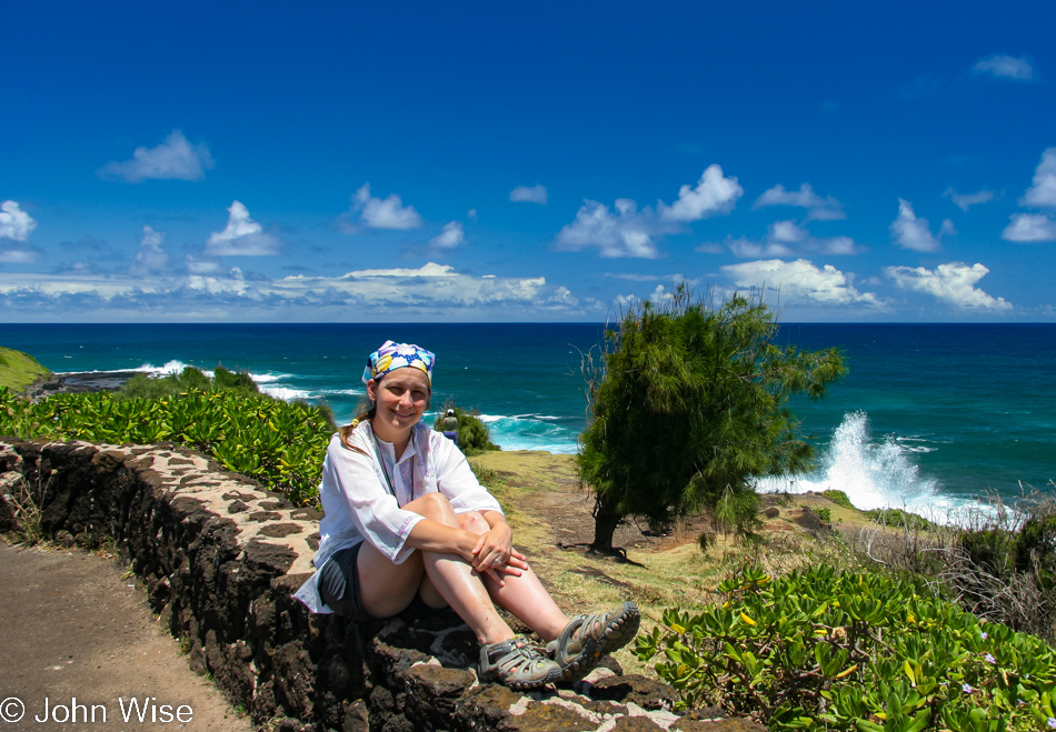 Caroline Wise sitting next to the ocean on Kauai, Hawaii