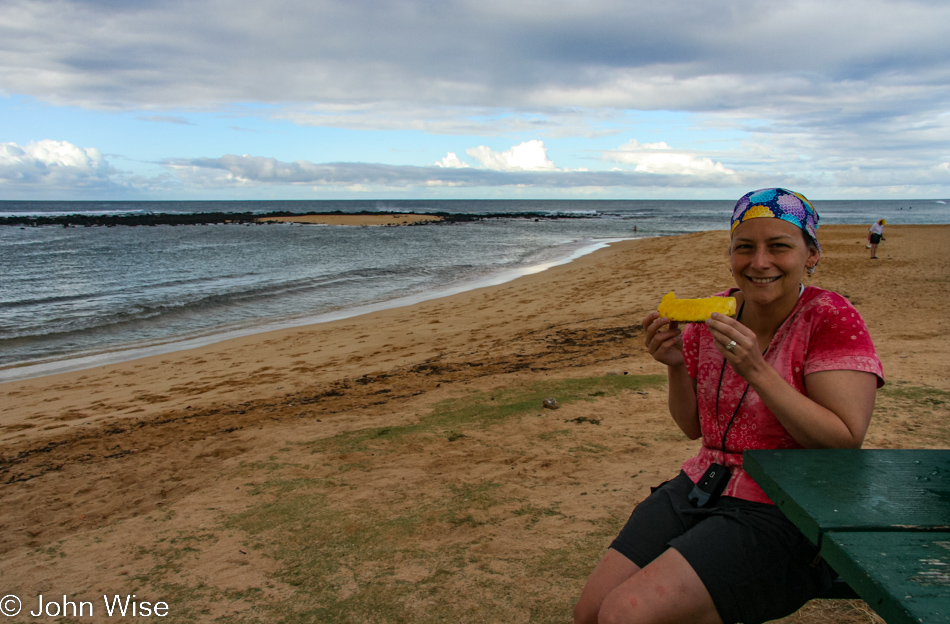 Caroline Wise enjoying fresh pineapple at Poipu Beach on the island of Kauai, Hawaii