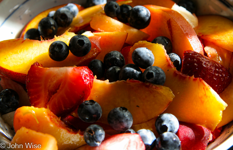 Mixed fresh fruit bowl with peaches, nectarines, strawberries, blueberries