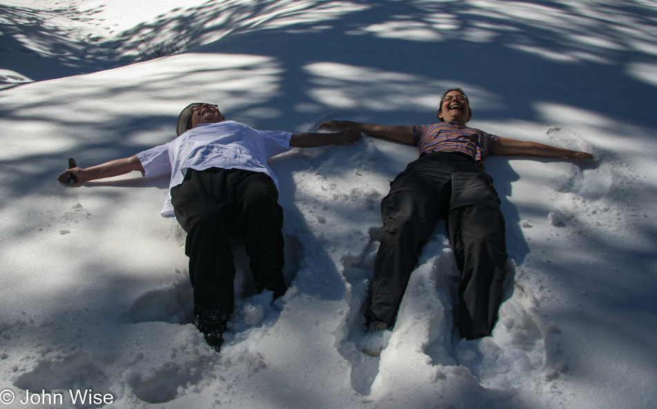 Jutta Engelhardt and Caroline Wise making snow angels on Mt Charleston in Nevada