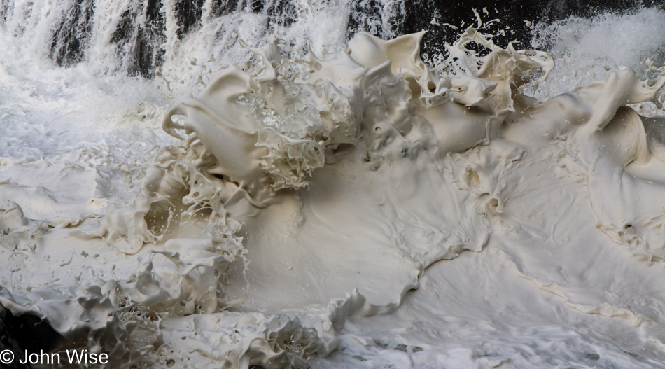 Foam being shot into the air from the roiling waves below at Devils Churn Cape Perpetua Scenic Area on the coast of Oregon