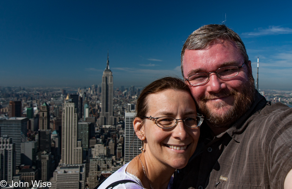 Caroline Wise and John Wise on Rockefeller Center in front of The Empire State Building in New York City