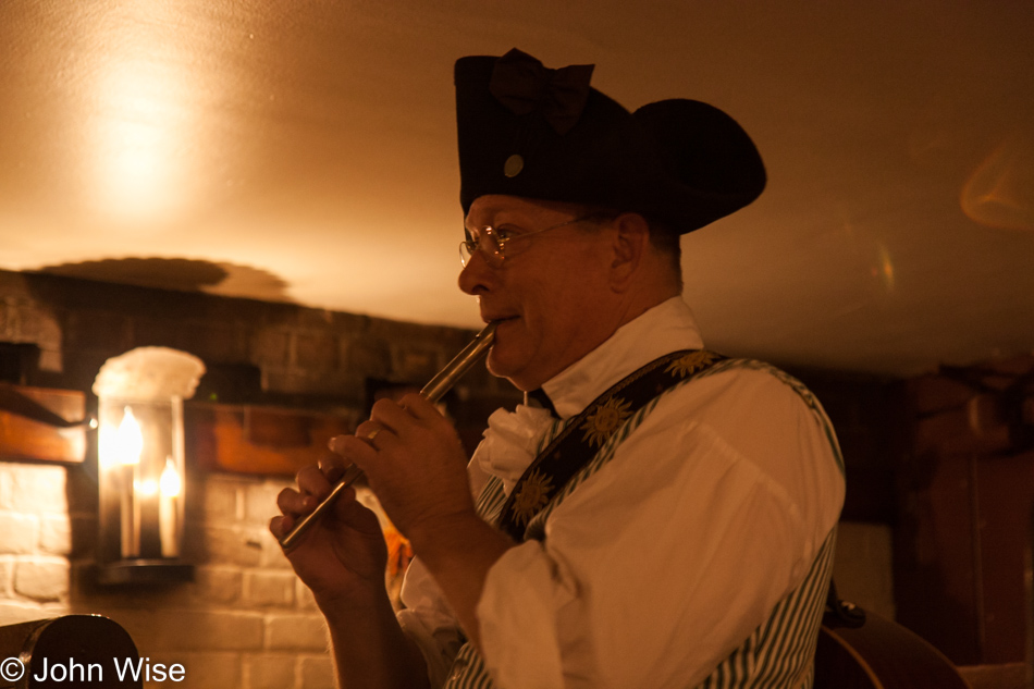 A gentleman in period costume at Christina Campell's Tavern in Williamsburg, Virginia playing a recorder