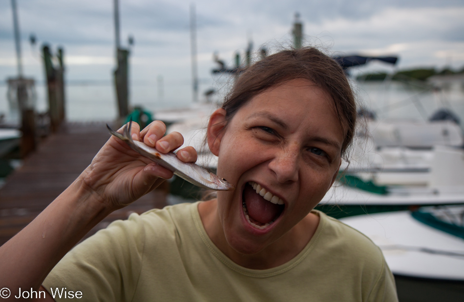 Caroline Wise about to eat a half frozen still raw fish at Robbie's Marina on Islamorada, Florida