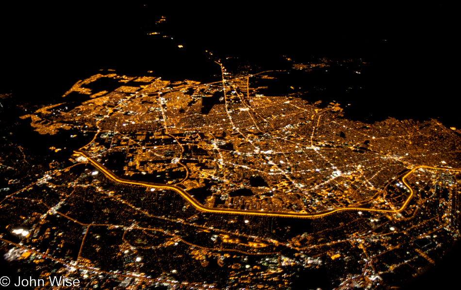 The illuminated cities of Juarez, Mexico and El Paso, Texas as seen at night from forty-thousand feet in the air