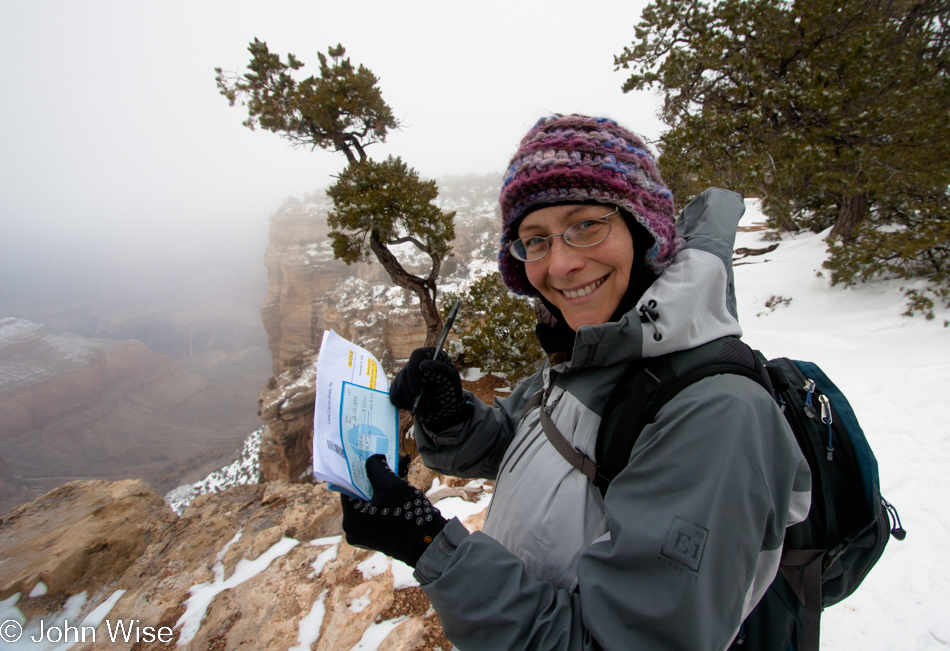 Caroline Wise signing our deposit check to raft the Colorado River through the Grand Canyon on a Dory in 2010