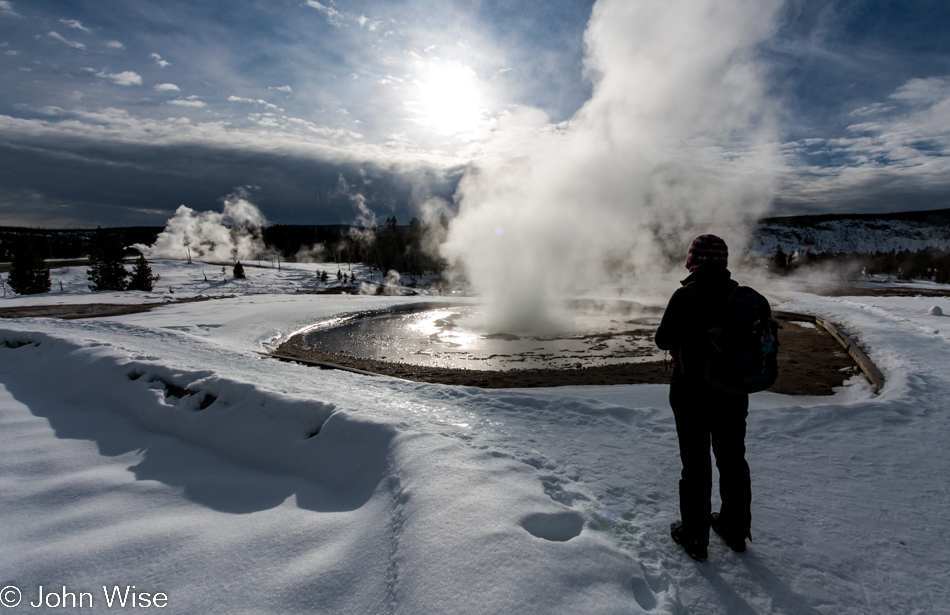 Caroline Wise at Sawmill Geyser erupting on the Upper Geyser Basin in Yellowstone National Park January 2010