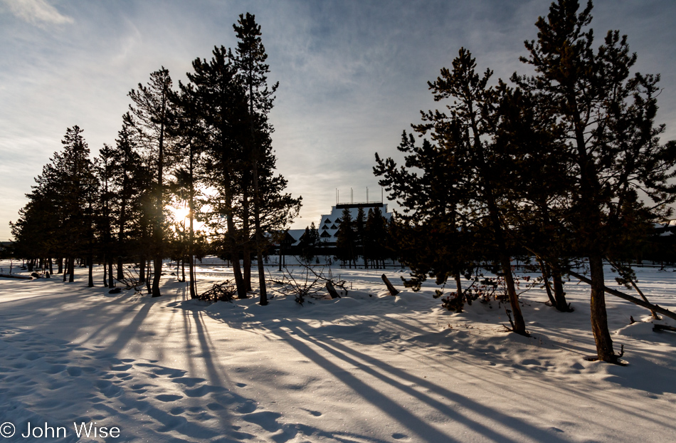 The sun rising behind Old Faithful Inn on the Upper Geyser Basin in Yellowstone National Park January 2010