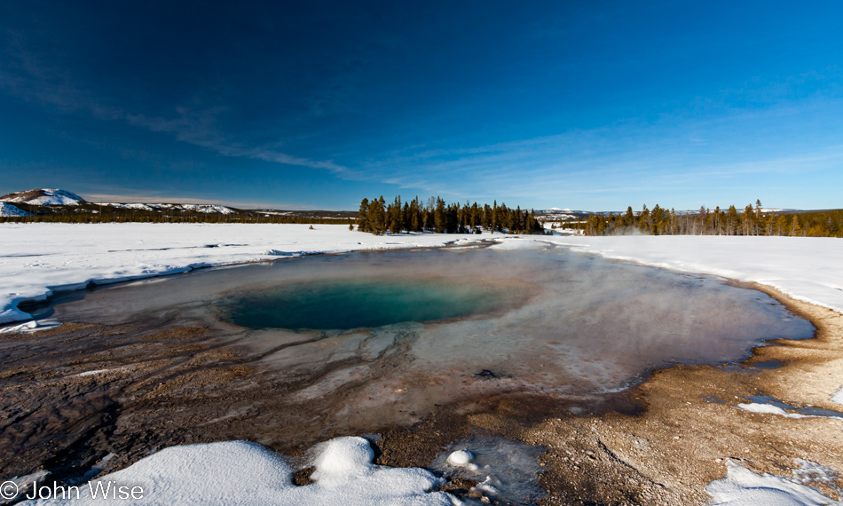 Turquoise Pool framed in snow on the Midway Geyser Basin in Yellowstone National Park January 2010