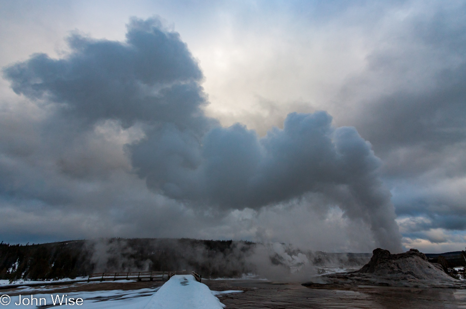 The rising steam of the erupting Castle Geyser against a late afternoon sky on the Upper Geyser Basin in Yellowstone National Park January 2010