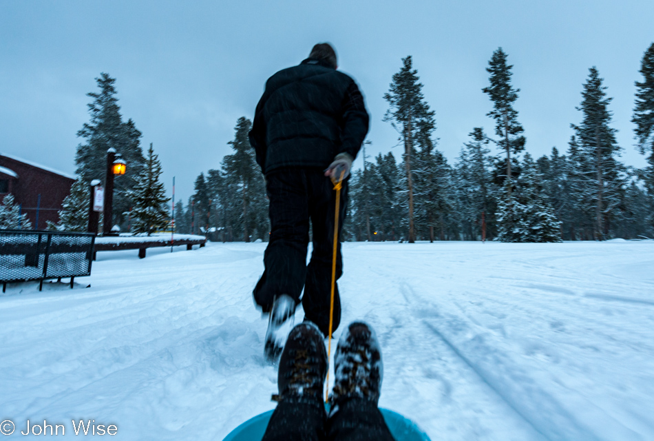 John Wise pulling Caroline Wise in a sled at Yellowstone National Park January 2010