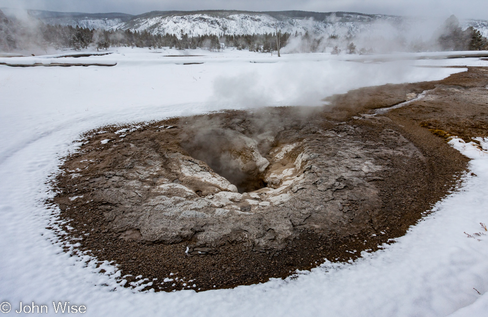 The empty pool of Oval Spring on the Upper Geyser Basin in Yellowstone National Park January 2010
