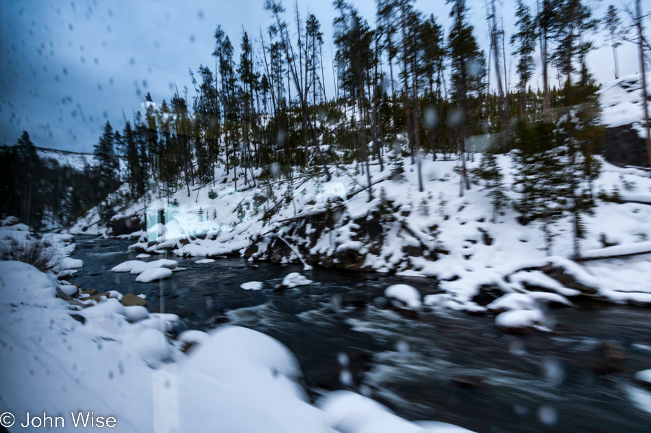 The blurred and spotted view out the window of a snow coach in Yellowstone National Park January 2010