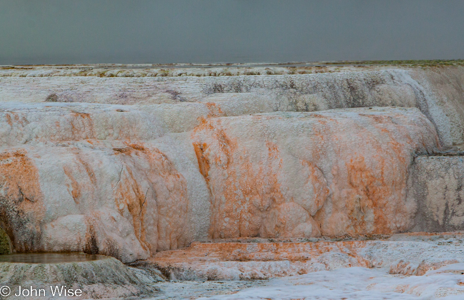 Orange-stained travertine terrace at Mammoth Hot Springs in Yellowstone National Park January 2010