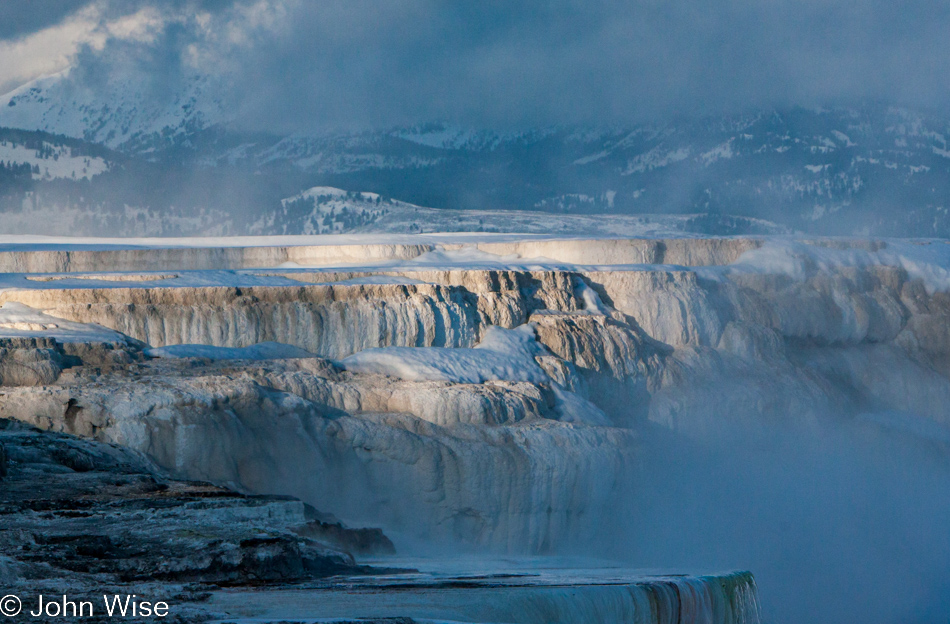 Steam rising off travertine terraces on the Upper Terrace at Mammoth Hot Springs in Yellowstone National Park January 2010