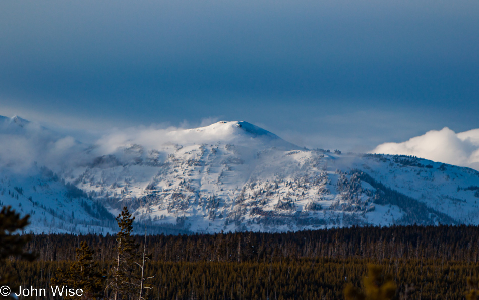 A snow covered mountain peak in the distance as seen from the Norris Geyser Basin in Yellowstone National Park January 2010