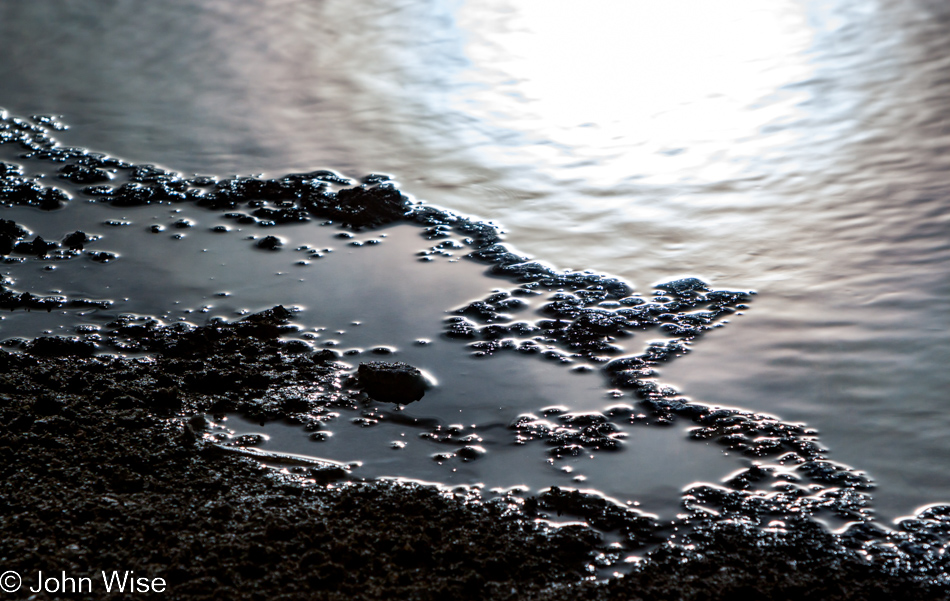 Hot spring water reflecting the sun at Black Sand Basin in Yellowstone National Park January 2010