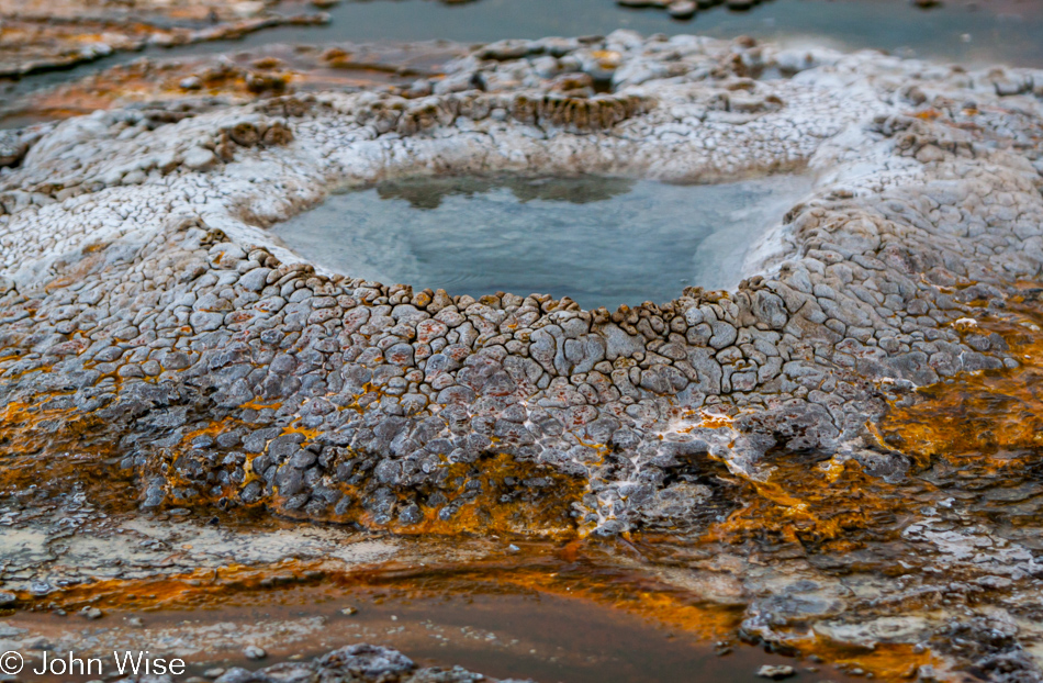 Stone detail and rust looking edges of a small geyser cone on the Upper Geyser Basin in Yellowstone National Park January 2010