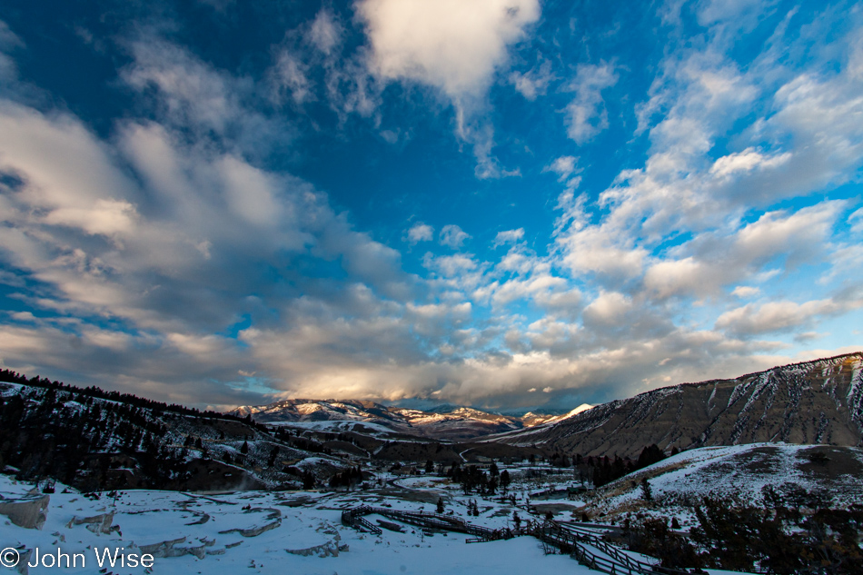 Approaching sunset with a wide overview of the Mammoth Hot Springs area with the Gallatin Range in the background in Yellowstone National Park January 2010