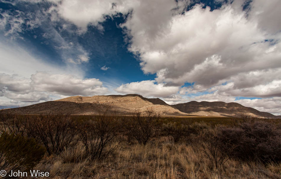 Big blue sky with clouds over a mountainy desert landscape in southern Arizona