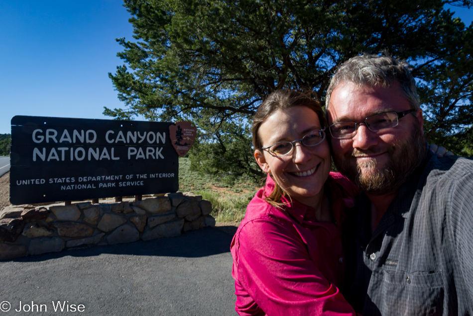 Caroline Wise and John Wise standing in front of the Grand Canyon National Park sign