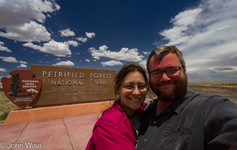 Caroline Wise and John Wise in front of the Petrified Forest National Park sign - Arizona