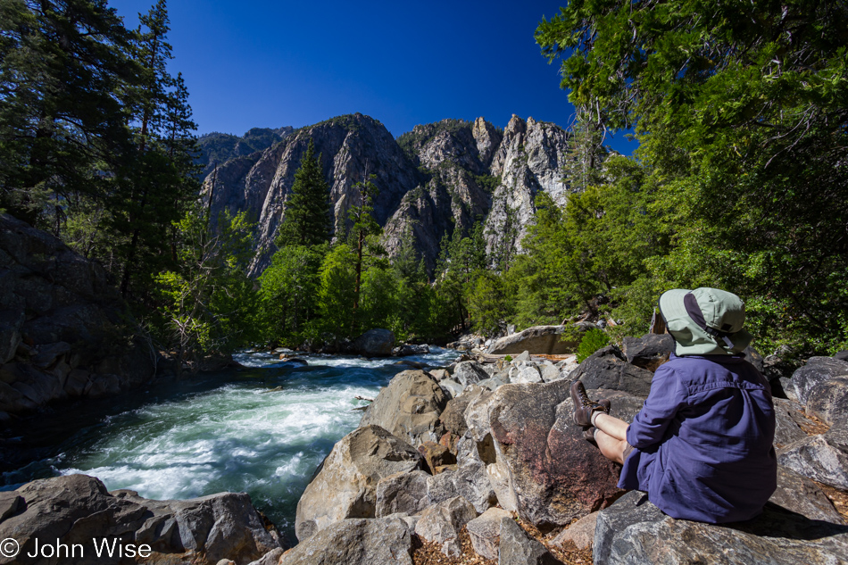 Caroline Wise sitting next to the Roaring River in Kings Canyon National Park in California