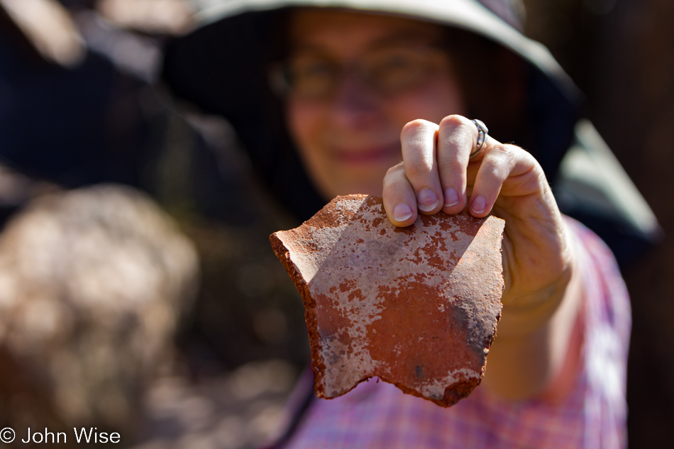 Caroline Wise holding a pottery shard.
